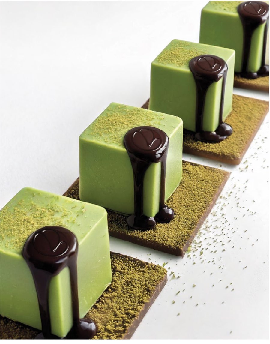 Pistachio cream petits gâteaux with dark chocolate seals