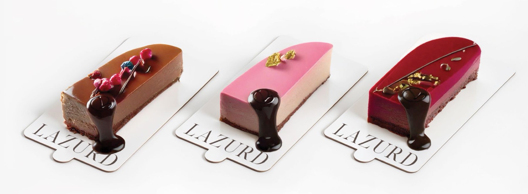 Three Lazurd signature cakes on branded boards
